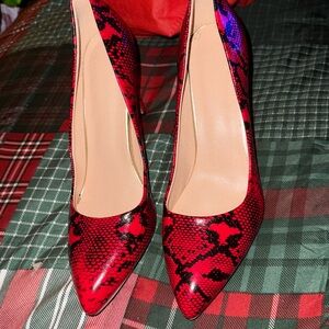 Red snake skin print high heel pumps. Size 9 1/2.
